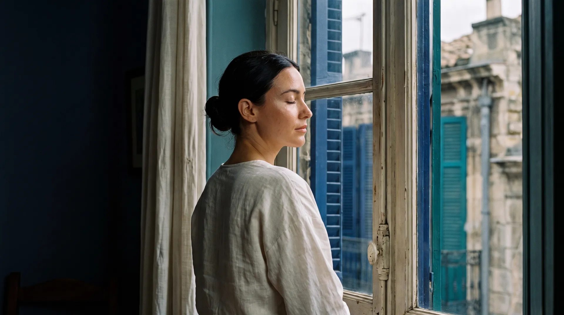 A woman's face in profile with eyes closed
